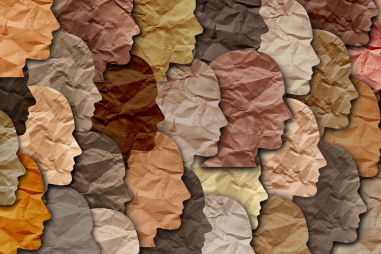Paper cut outs of faces in different colours