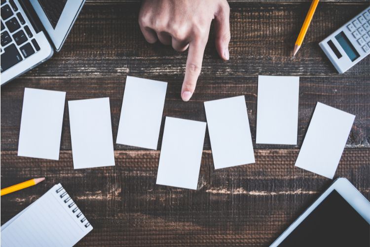 Hand pointing at cards to select