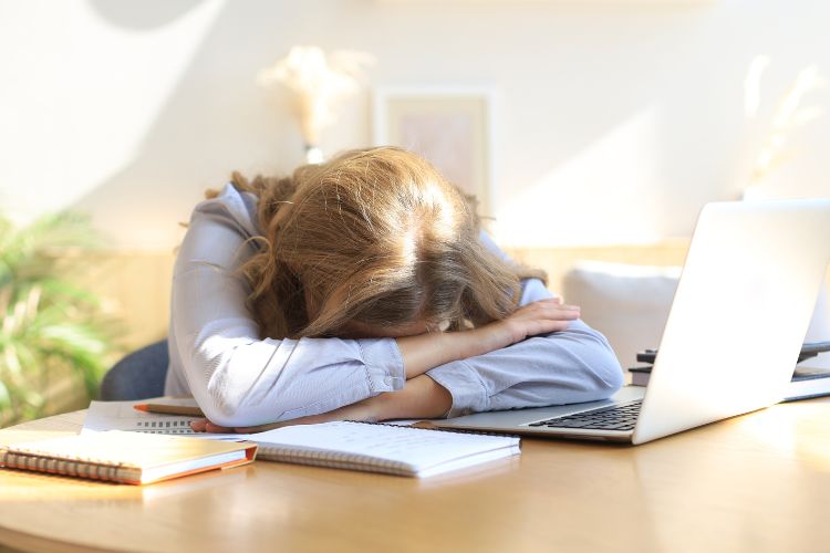 Woman with head on desk