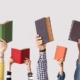 Hands with books in the air